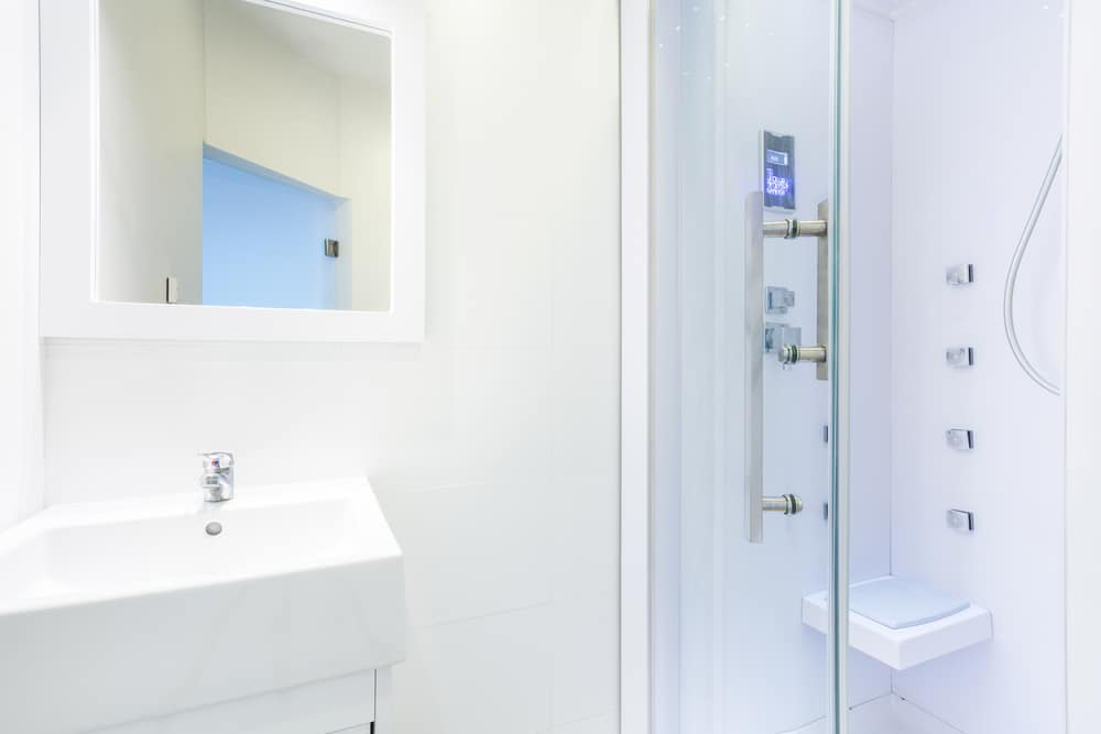 Low-entry shower with clear glass door in a residential bathroom