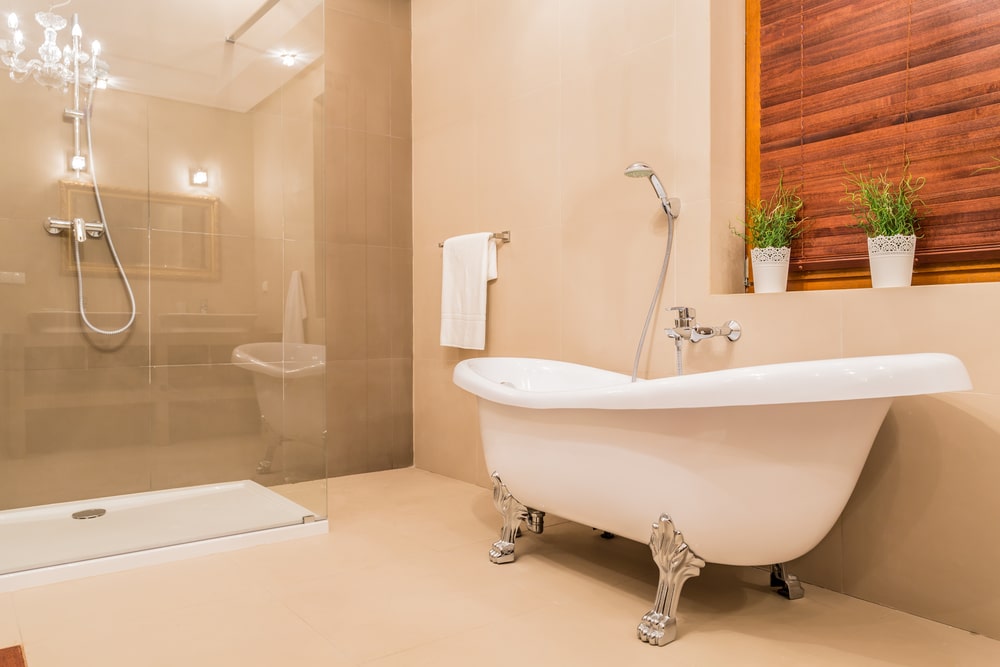 Updated bathroom with glass shower and porcelain bathtub