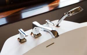 Bath tap and shower fixture close-up for replacement budgeting